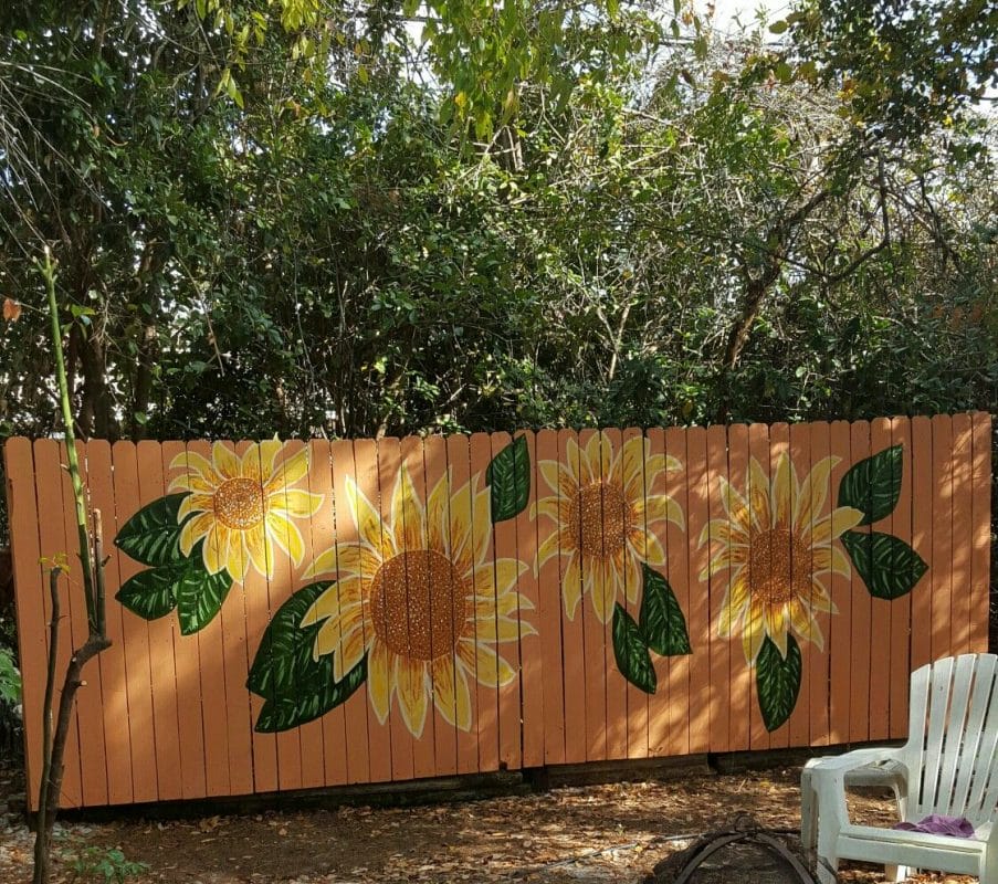 sunflower murals on wooden fences