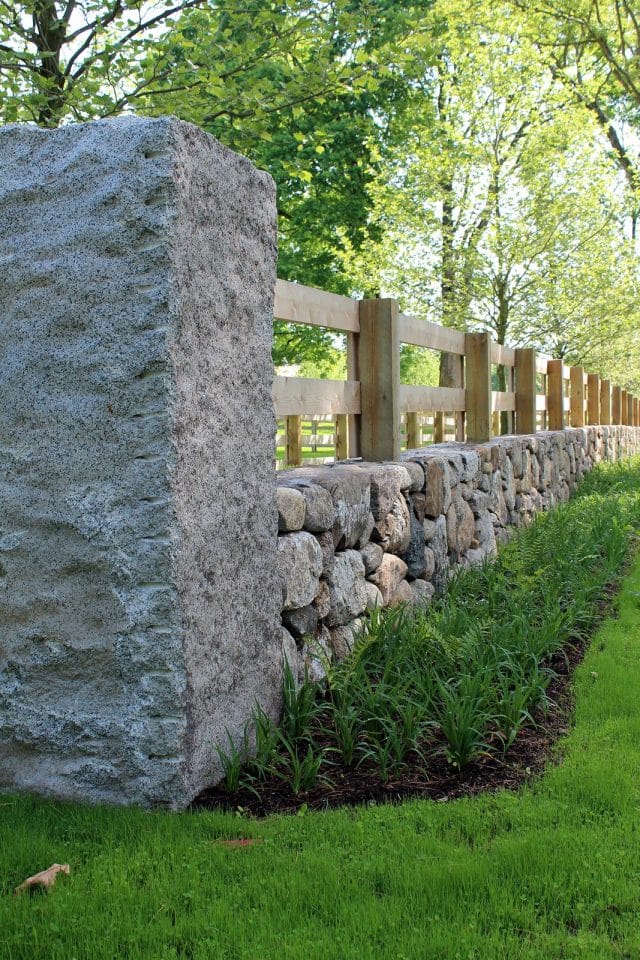 simple stone and wood horse fence